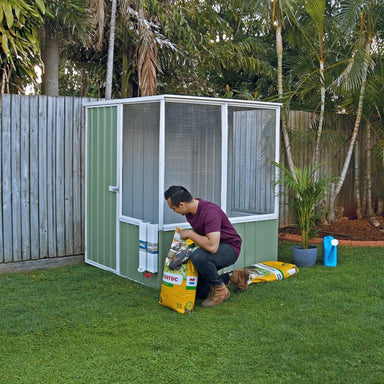 absco-chicken-coop-man-preparing-feed