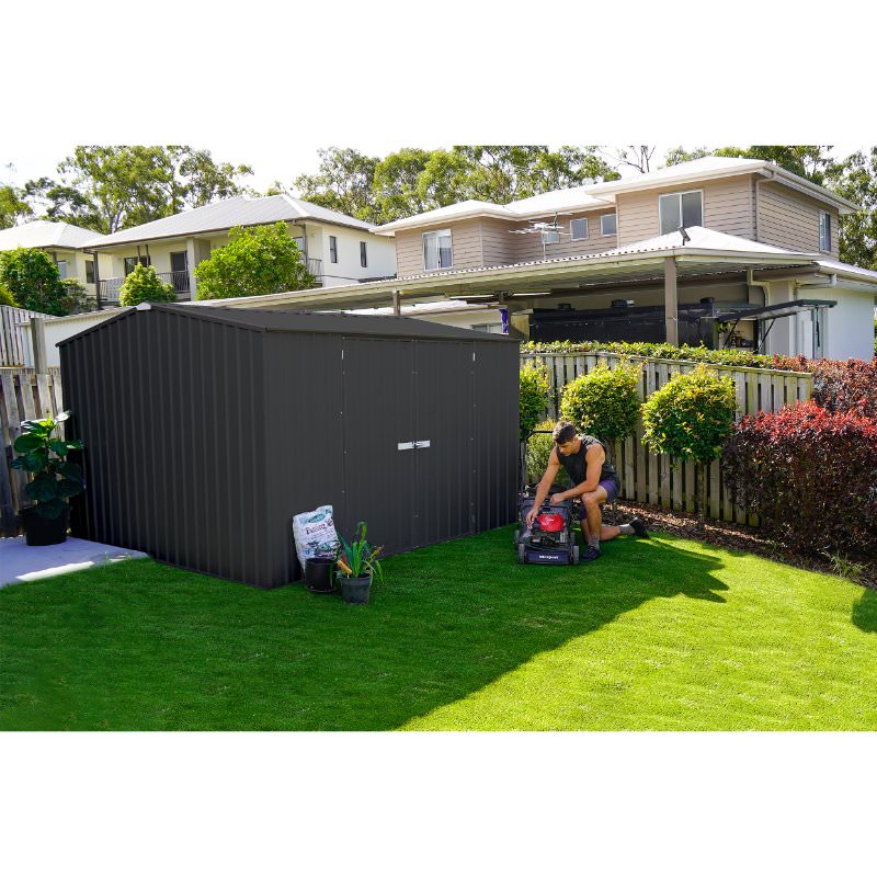 absco-premier-metal-shed-ab100-man-tinkering-with-lawnmower