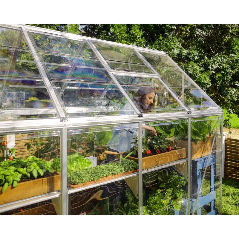 canopia-hybrid-greenhouse-woman-looking-at-plants