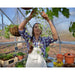 canopia-hybrid-greenhouse-woman-tending-to-hanged-plants