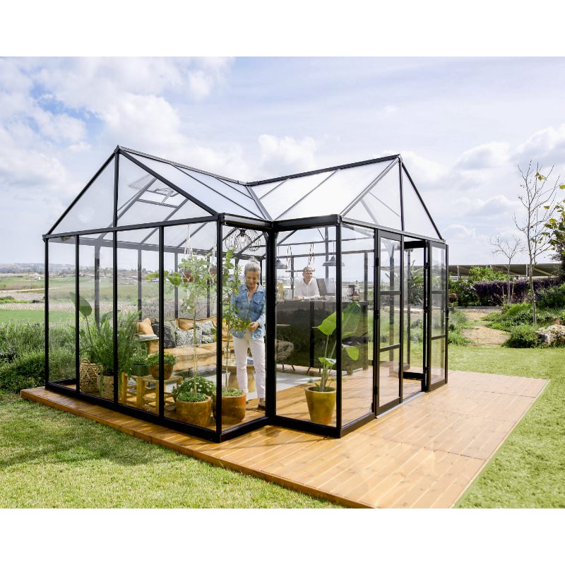 canopia-triomphe-orangery-greenhouse-woman-tending-to-plants-inside