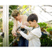 palram-canopia-hybrid-greenhouse-woman-and-kid-watering-plants