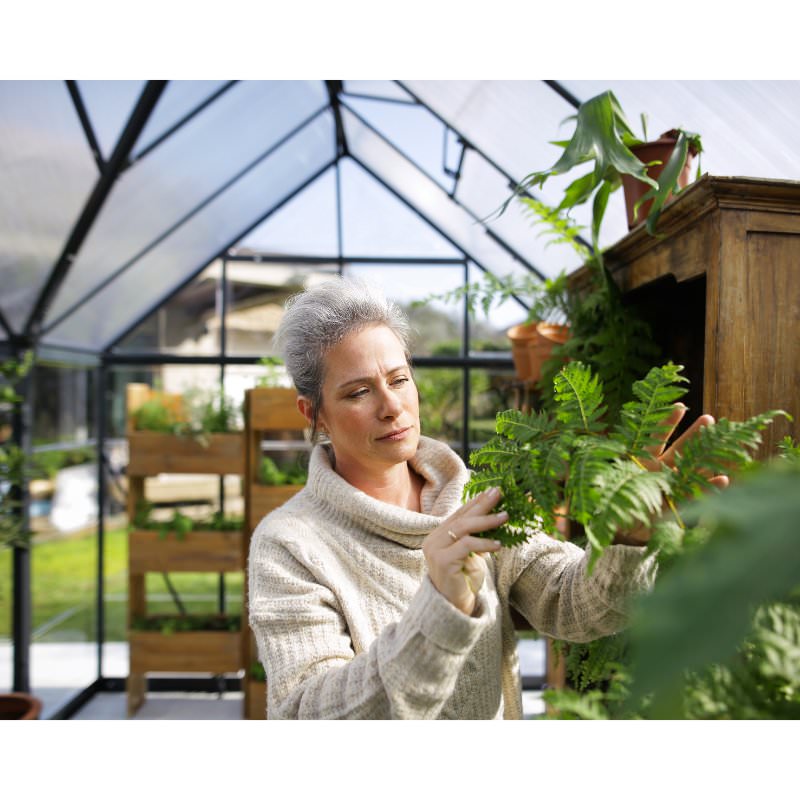 palram-victory-orangery-woman-tending-to-plants