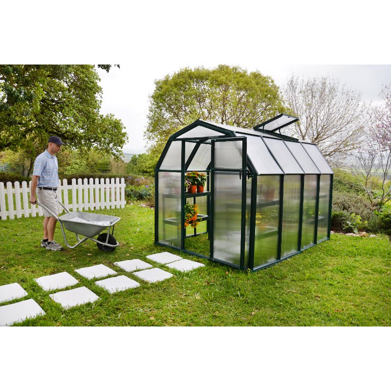 rion-ecogrow-greenhouse-man-pushing-wheelbarrow-towards-greenhouse