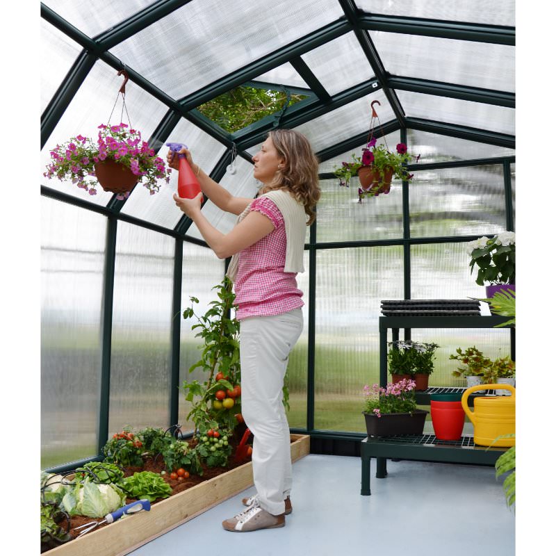 rion-hobby-gardener-greenhouse-woman-tending-to-hanging-plants