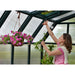 rion-hobby-greenhouse-woman-hanging-plants-inside